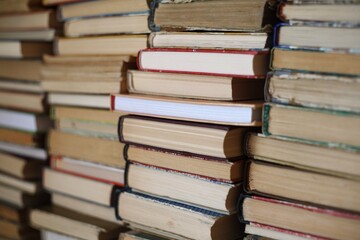 Stacked books in a cozy library corner waiting to be read