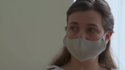 Concerned woman wearing face mask looking away - Powered by Adobe
