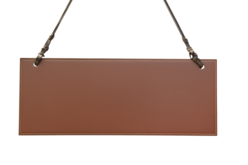 Rectangular brown leather sign with black straps and silver clips on transparent background