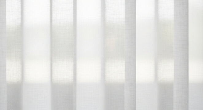 Vertical sheer white curtains with soft light filtering through them fabric