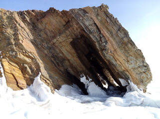 Winter rock formation on Lake Baikal in sunlight