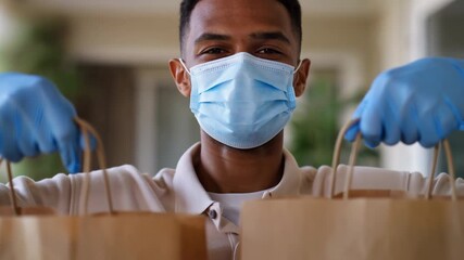 resilient community service featuring masked courier delivering groceries contactlessly at residences