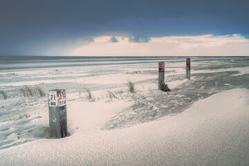 Afternoon seacoast landscape with view on the beach during stormy weather.