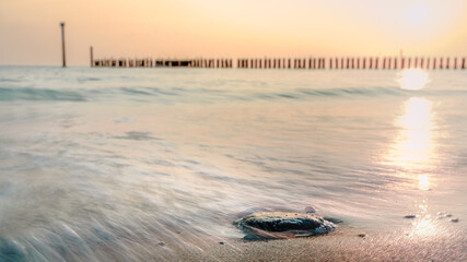 Motion blur Waves at the sea during sunset at Dutch coast of Zeeland