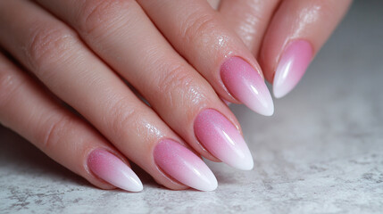 Elegant manicure with a pink and white gradient, showcasing the beauty and detail of expertly crafted nails. 