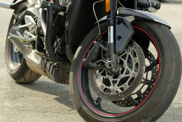 Obraz premium A sports motorcycle.Close-up. Motorcycle structural elements. The front wheel. Front brake elements, front shock strut.