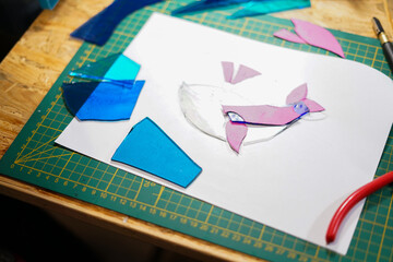 Making stained glass during artistic workshop. 