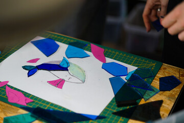 Making stained glass during artistic workshop. 