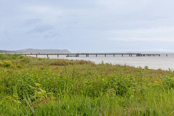 Fototapeta premium Distant view of the long pier in Gohren of which 270 metres projects into the Baltic Sea