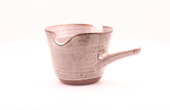 Artisanal Ceramic Pouring Vessel with Handle and Spout Isolated on White - Powered by Adobe
