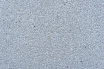 uniform light grey fine-grained stone or concrete surface texture, detailed abstract construction background, concept of building material, architecture, interior design