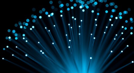Abstract blue glowing fiber optic lights spreading out from a central point on a dark background, representing data transfer and connectivity