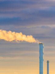 Smokestacks releasing steam at sunset in Gothenburg creating a colorful skyline