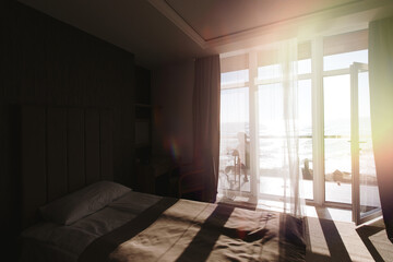 A hotel room or a room with a sea view. A ray of sunlight streams through the window.