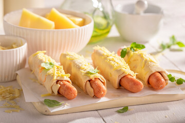Delicious hot dogs with herbs, puff pastry and cheese.