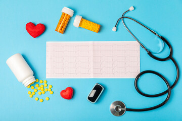 Medical stethoscope, red heart, and cardiogram on a color background. ECG, Heart wave, heart attack, cardiogram report. Cardiogram pulse trace and heart concept. Healthcare.Space for text
