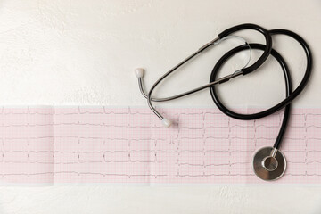 Medical stethoscope, red heart, and cardiogram on a color background. ECG, Heart wave, heart attack, cardiogram report. Cardiogram pulse trace and heart concept. Healthcare.Space for text