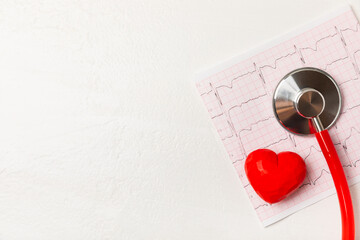 Medical stethoscope, red heart, and cardiogram on a color background. ECG, Heart wave, heart attack, cardiogram report. Cardiogram pulse trace and heart concept. Healthcare.Space for text