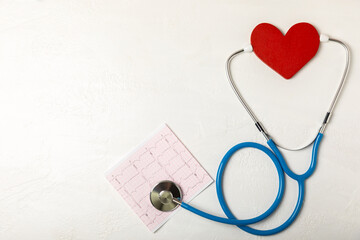 Medical stethoscope, red heart, and cardiogram on a color background. ECG, Heart wave, heart attack, cardiogram report. Cardiogram pulse trace and heart concept. Healthcare.Space for text