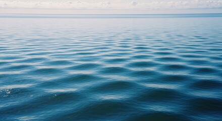 Calm and Serene Ocean Waves with Gentle Ripples Under a Clear Sky on a Sunny Day