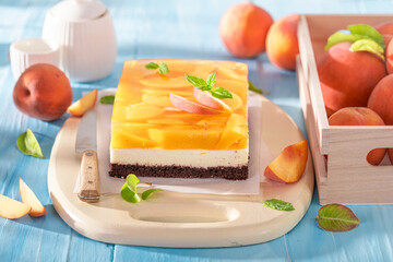 Homemade jelly peach cheesecake made with jelly, fruits and foam.
