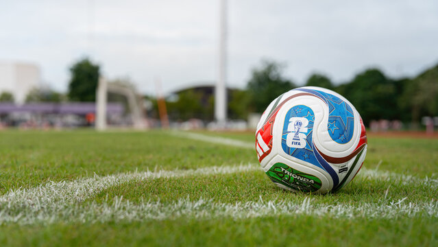 Bangkok, Thailand - 18 November 2025: Adidas "Trionda" the official match ball for Fifa World Cup 2026 that co-host in America. The ball is placed on grass pitch with football stadium component.