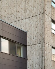Modern architecture meets brutalist concrete facade: contrasting textures and styles
