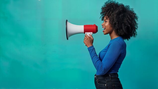 Confident young African American woman with afro hair speaking into a megaphone on a bright turquoise background. - Powered by Adobe