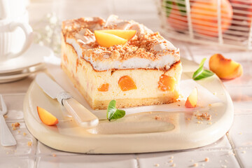 Sweet and homemade peach cheesecake with fruits, meringue and foam.
