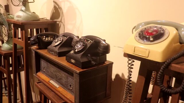 An old typewriter dating back 150 years and Antique collection including a collection of old telephones, an old fan, and an old-fashioned radio