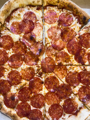 Regular homemade pepperoni pizza, pizza with sausage, cheese, and tomato paste, junk food, healthy...