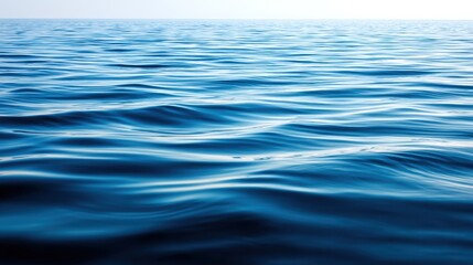 Naklejka premium Tranquil Ocean Waves Gently Rippling Under Bright Blue Sky, Serenity and Calmness Captured in Stunning Seascape Photography for Nature Lovers