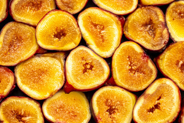 Figs close-up. Heap of figs, whole fruits and cut in half. Sweet exotic fruit for dessert, healthy food.
