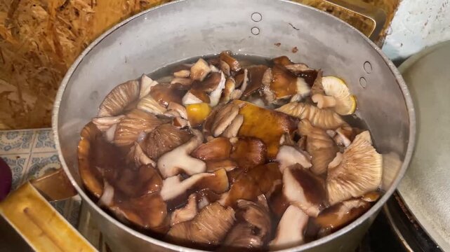 boiling honey mushrooms in cooking pot
