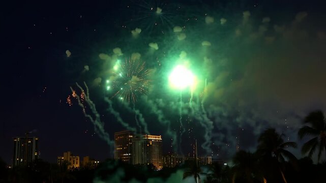 Spectacular fireworks exploding over city skyline
