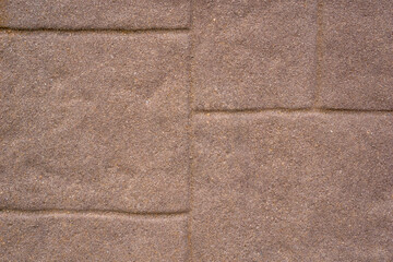 Fototapeta premium textured brown concrete paving stones with defined mortar lines, close-up uniform pattern, concept of construction, building material, landscaping