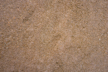 fine grained tan brown sand or concrete surface texture with subtle darker stain, detailed earth tone construction background, concept of building material, architecture, aged flooring