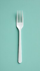 A striking flat lay of white plastic cutlery elegantly arranged against a vibrant blue background, showcasing culinary creativity and simplicity