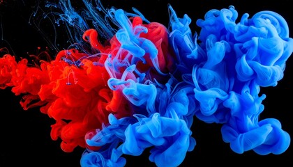 Obraz premium Red and blue ink swirling in water against black background, forming vibrant cloud-like patterns.