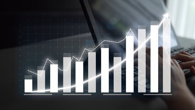 A hands-on view of data visualization showcasing a growth trend graph on a laptop screen in a modern office, symbolizing business progress and performance analysis. Copula