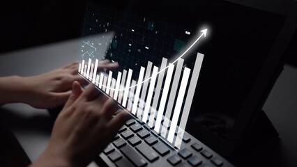 Focused hands typing on a laptop with an overlay of rising financial chart, symbolizing data analysis and growth potential in a modern business environment. Copula