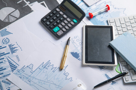 Pen and calculator on a financial graphs. Business