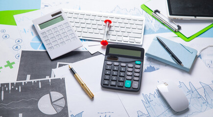 Pen and calculator on a financial graphs. Business