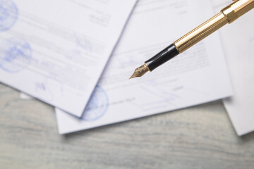 Pen and contract on the table.