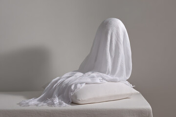warm scarf draped elegantly on pristine white pillow presenting cozy and inviting atmosphere