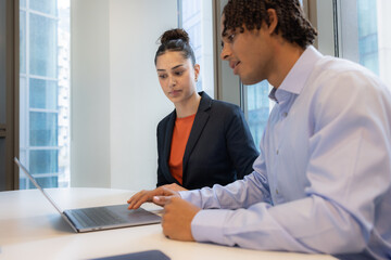Team collaboration over a laptop in a meeting