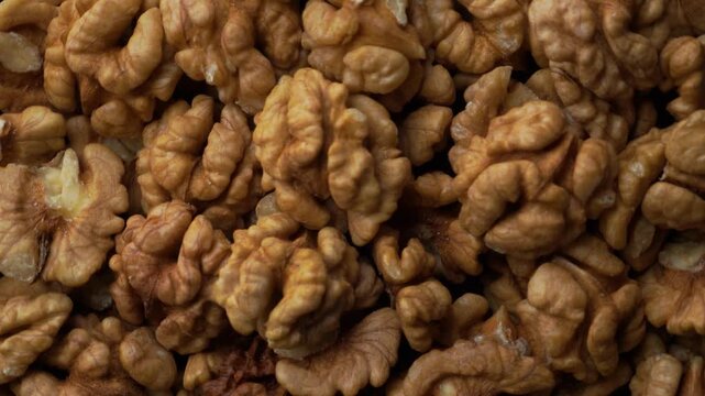 Flatlay macro loop of walnut kernels background texture