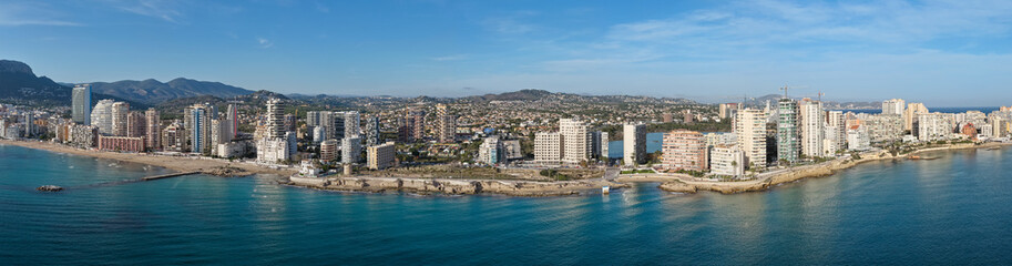 Fototapeta premium Aerial View of Calp, Spain and the Extensive Condos, Villas, and Prime Real Estate by the Majestic Peñón de Ifach on the Mediterranean Coast