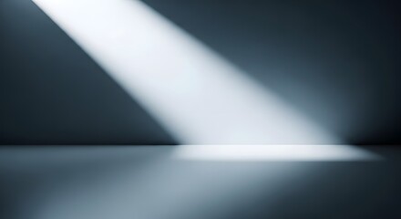 Dramatic spotlight beam illuminating a dark empty room with a reflective floor surface