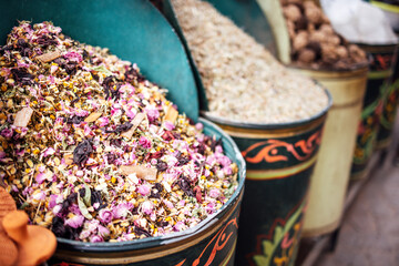 Colorful assortment of dried herbs and flowers in decorative containers, showcasing vibrant textures and natural beauty, perfect for culinary or aromatic uses in various applications